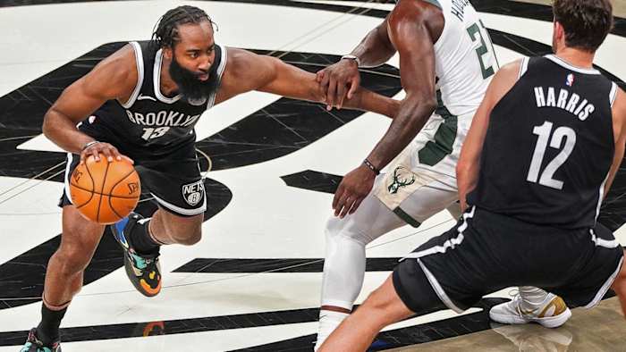 James Harden dribbles against the Bucks